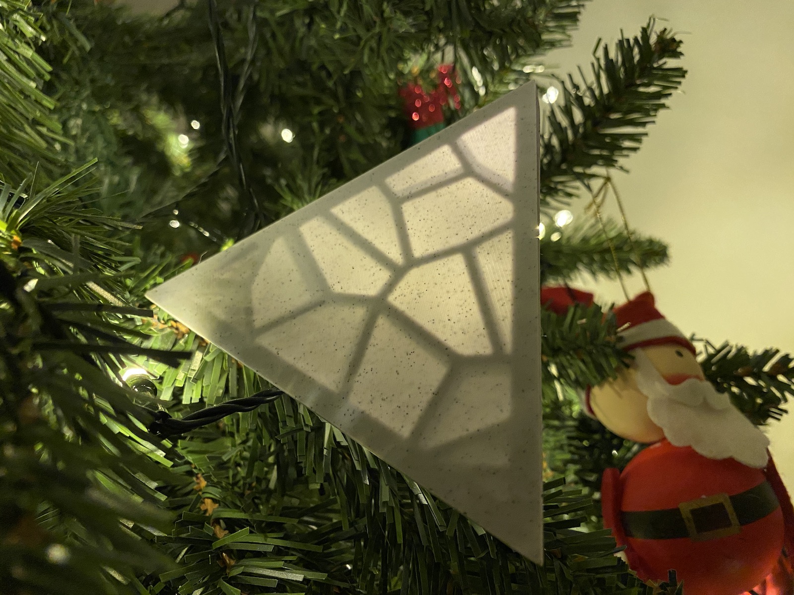 a 3d printed pyramid hanging in a christmas tree